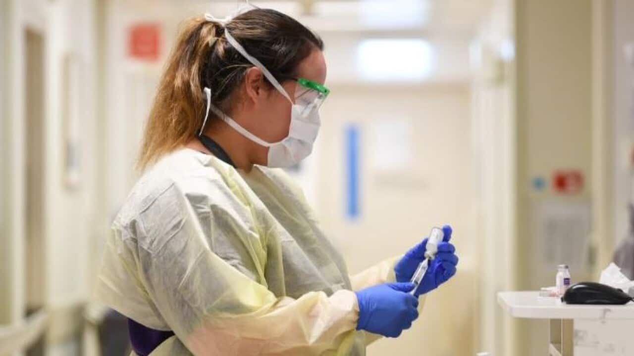 A healthcare worker conducts coronavirus screening inside a Melbourne hospital.