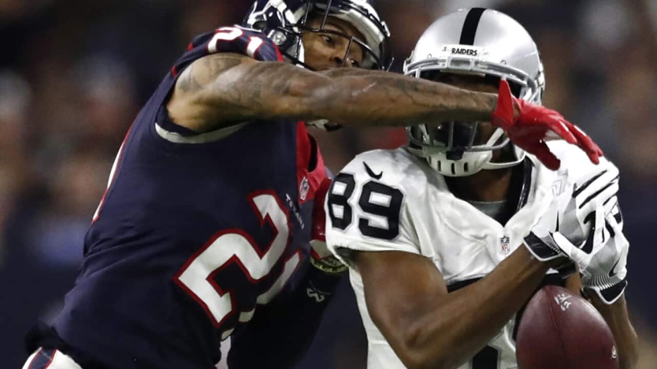 A.J. Bouye (L) knocks the ball away against Amari Cooper (R)