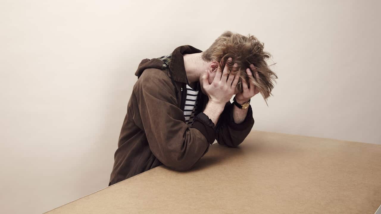 Portrait of man with his head in his hands