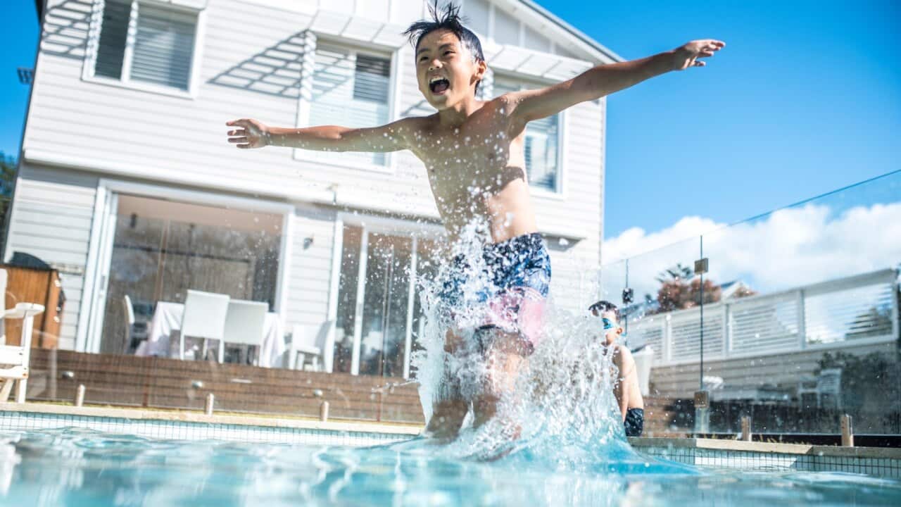 boy jumping in a pool