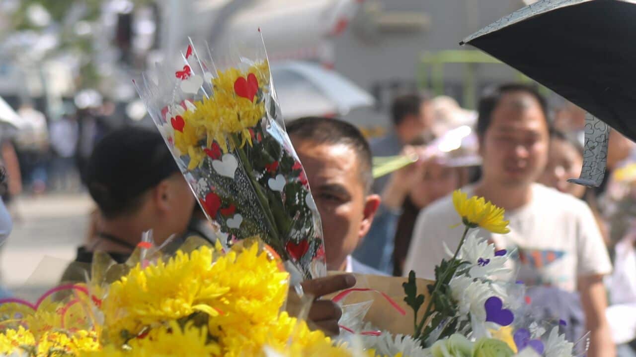 A woman mourns the loss of people and firefighters killed in a forest fire in Muli county.