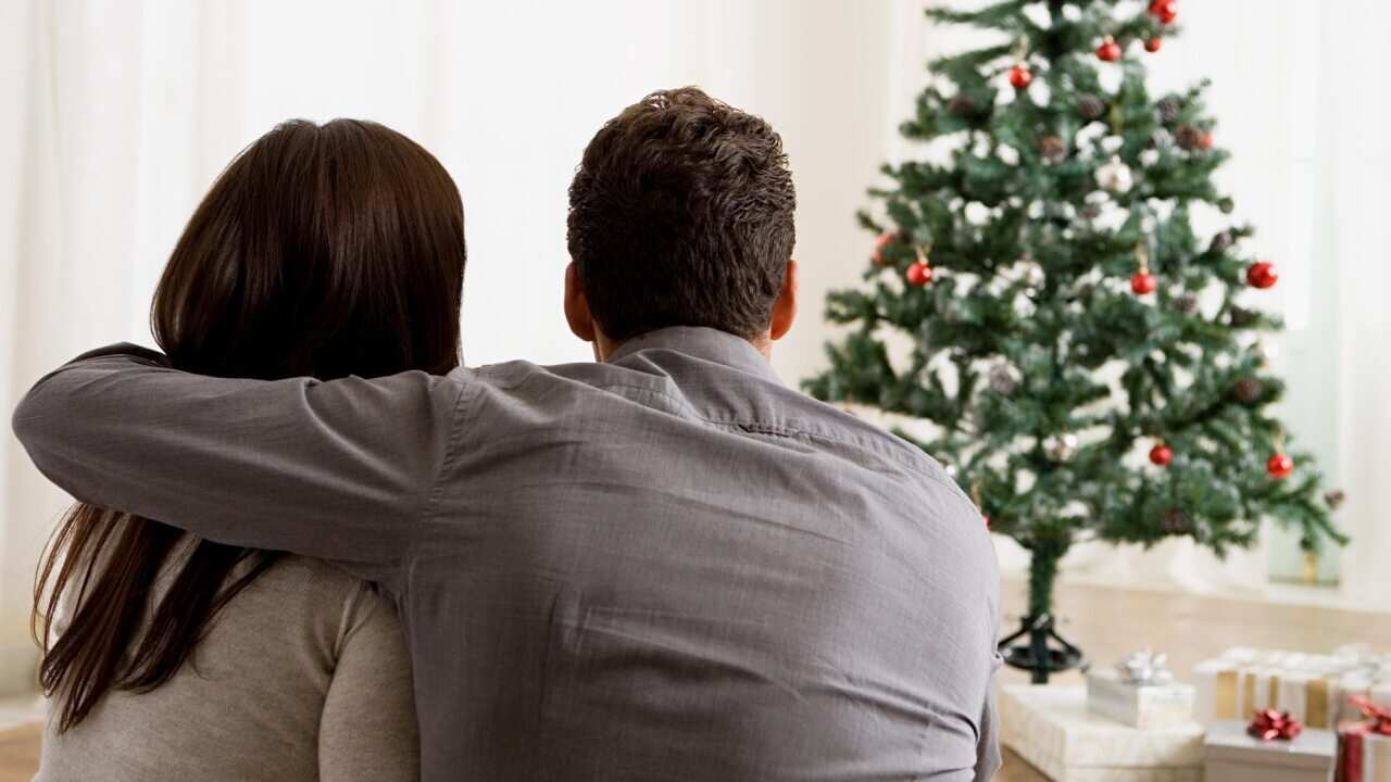 Couple looking at christmas tree