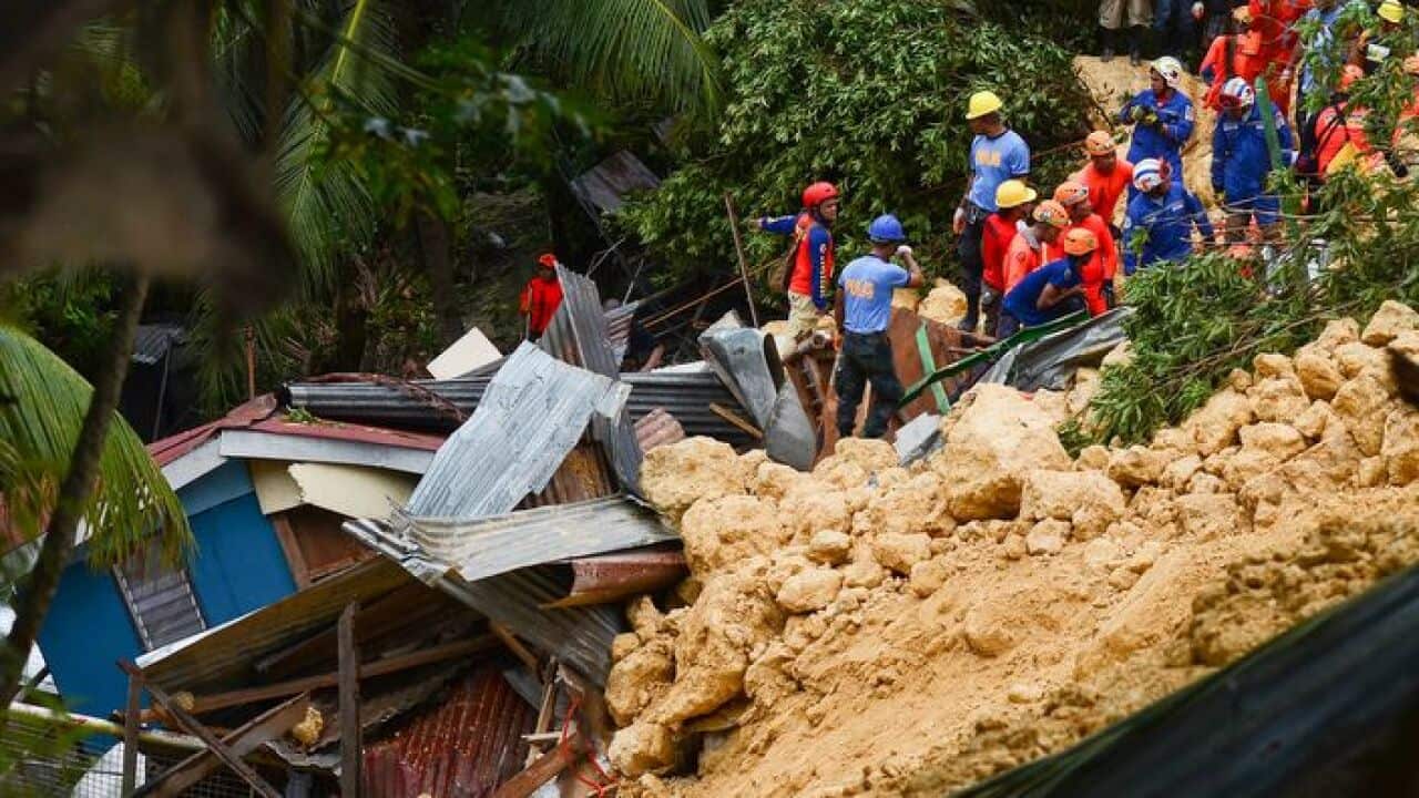 Rescuers search for survivors at the landslide site in Naga City, on the popular tourist island of Cebu on September 20, 2018