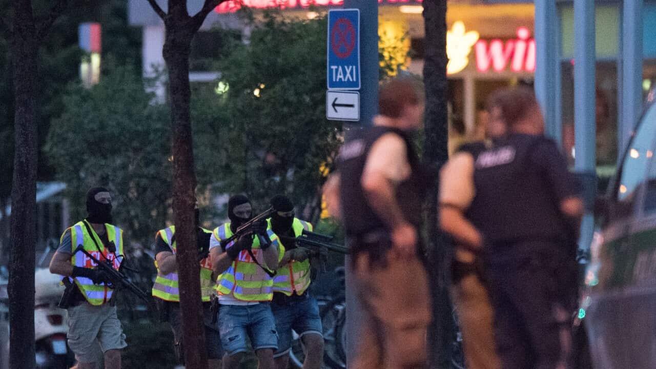 Special police forces prepare to search a neighbouring shopping centre outside the Olympia mall in Munich, southern Germany, Friday, July 22, 2016 after several people have been killed in a shooting. (AP Photo/Sebastian Widmann)