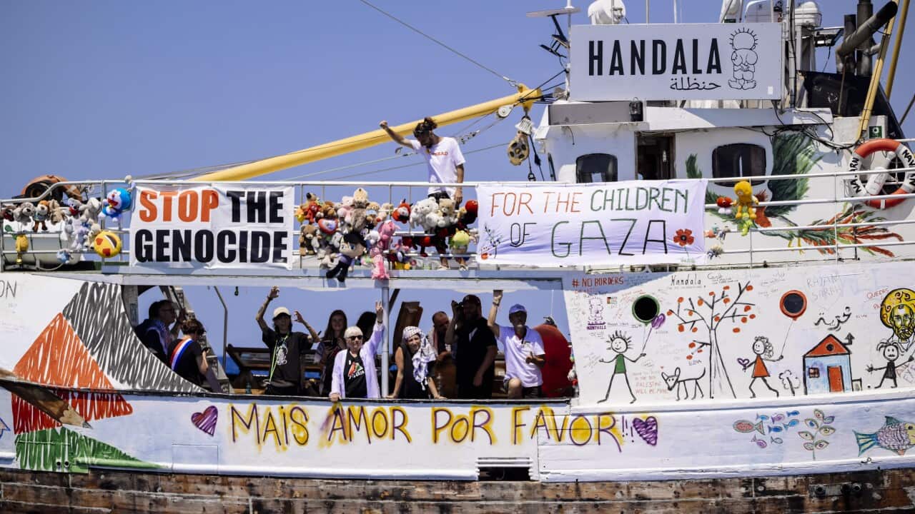 A boat with colourful drawings and signs sets sail