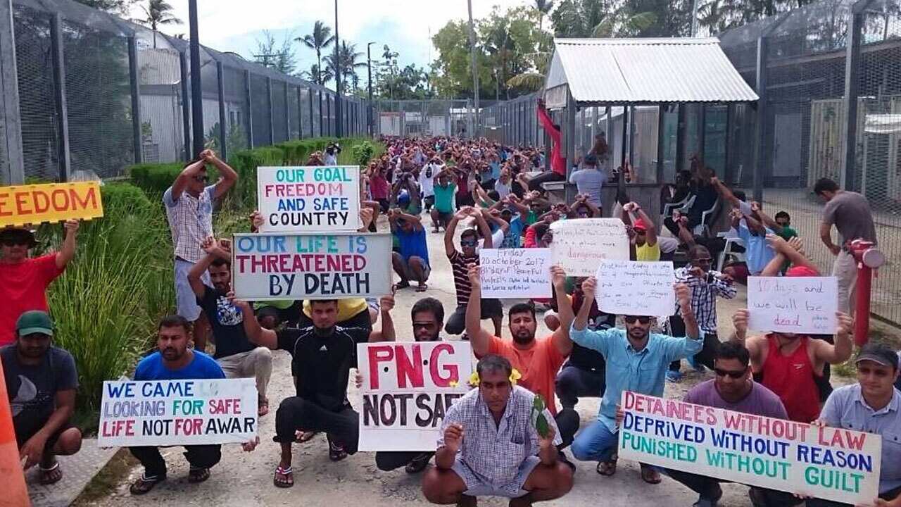 File image of refugees and asylum seekers holding up banners during a protest at the Manus Island immigration detention centre in Papua New Guinea.