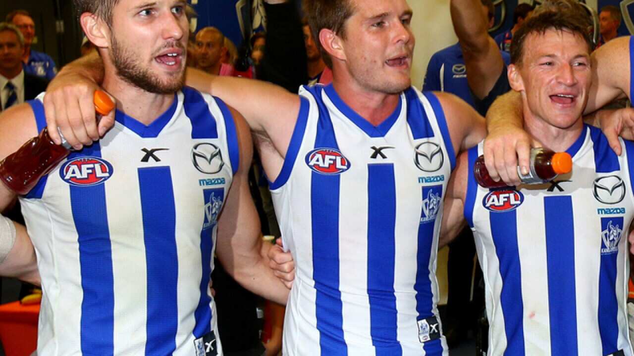 North Melbourne players celebrate defeating Port Adelaide