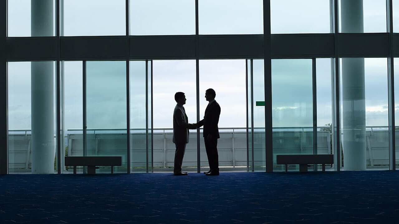 Businessmen Shaking Hands in doorway