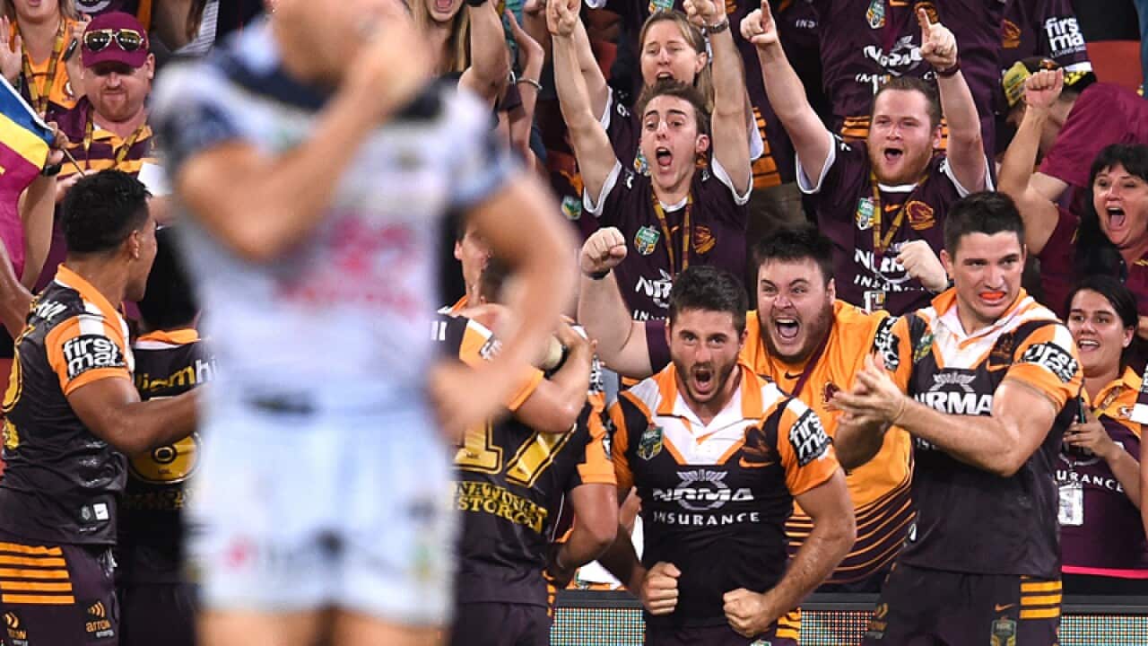 Brisbane Broncos players and fans celebrate.