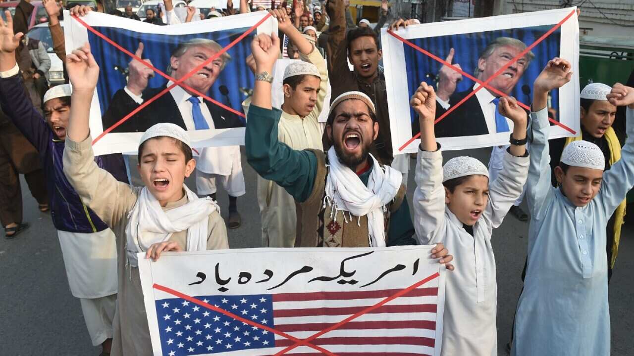 Pakistani demonstrators take part in a protest against US aid cuts in Lahore.