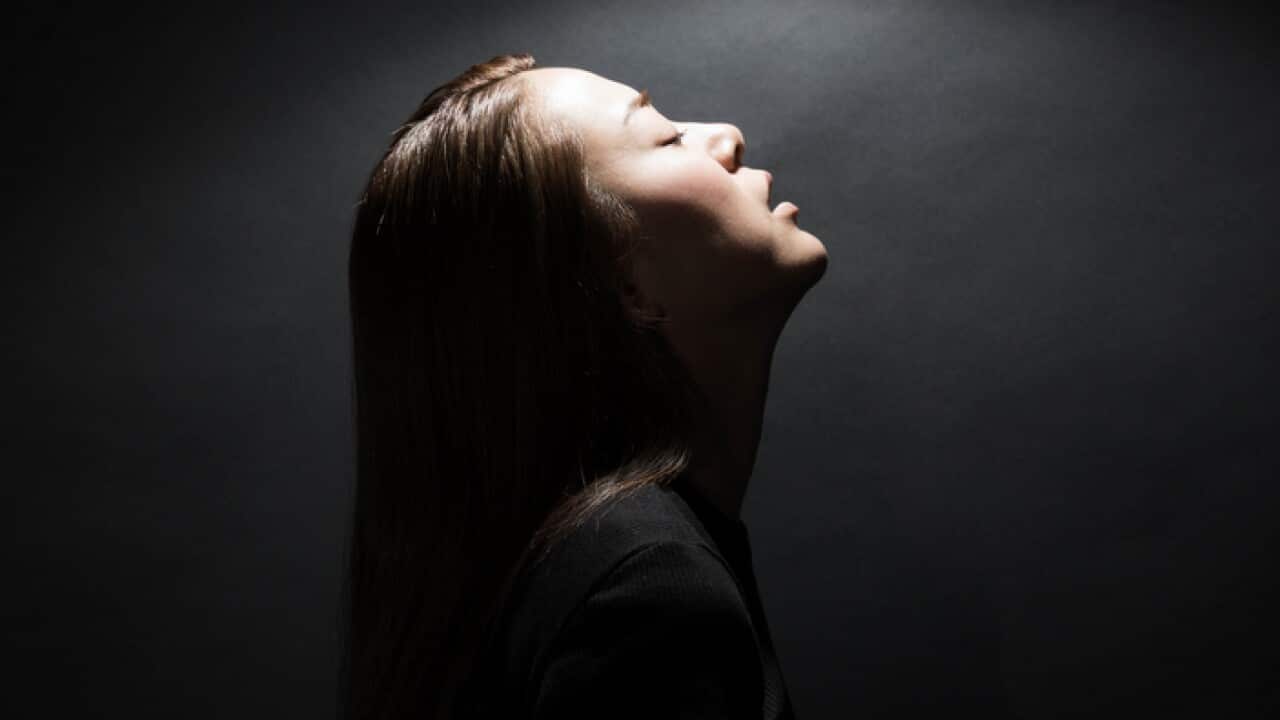 Exhausted young woman with eyes closed.