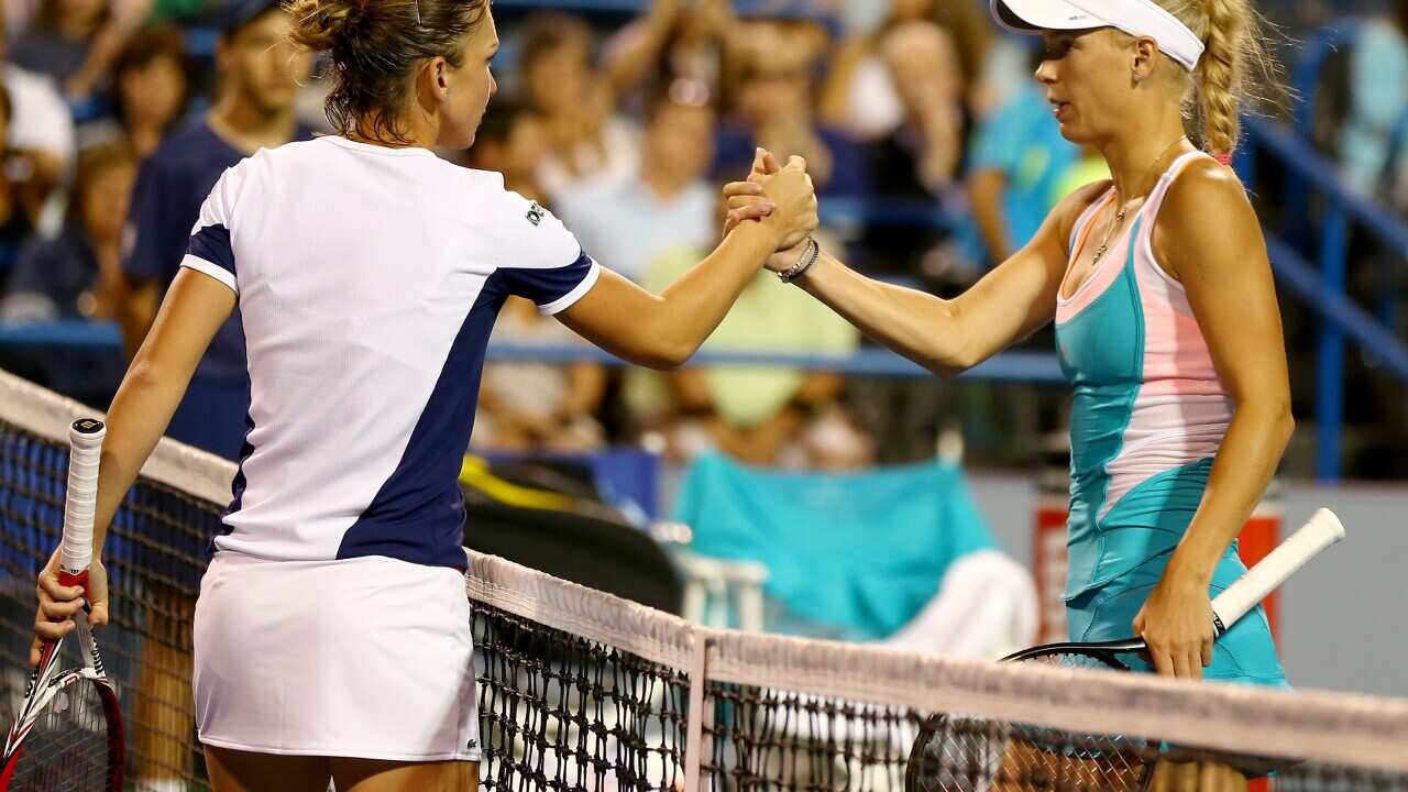 Long-time rivals: Simona Halep greets Caroline Wozniacki after the match at the New Haven Open back in 2013