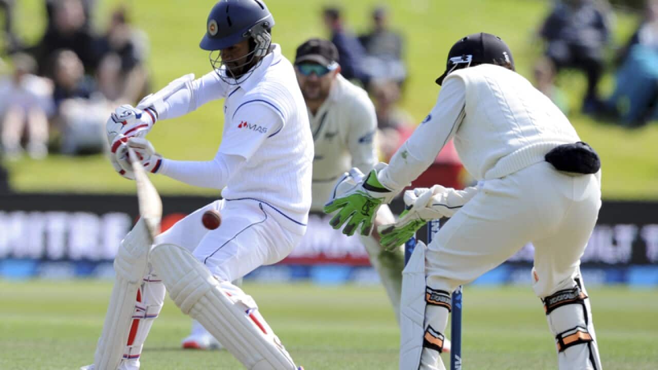 Sri Lanka’s Dimuth Karunaratne, left, and New Zealand’s BJ Watling