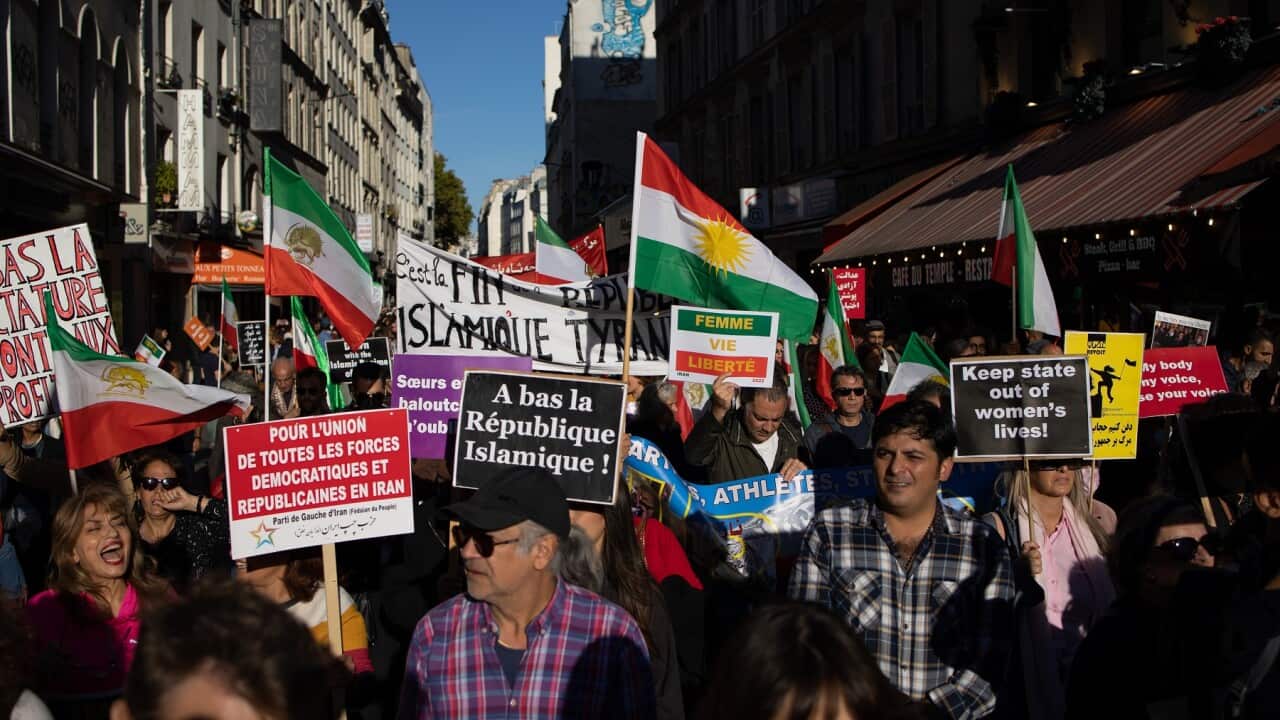 Protesters hold banners and signs at Republic Square Paris in support of Iranian women.