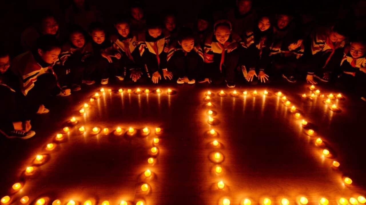 Students light candles to mark the Earth Hour, inspiring people to take action to protect and preserve the natural environment of the planet in north China.