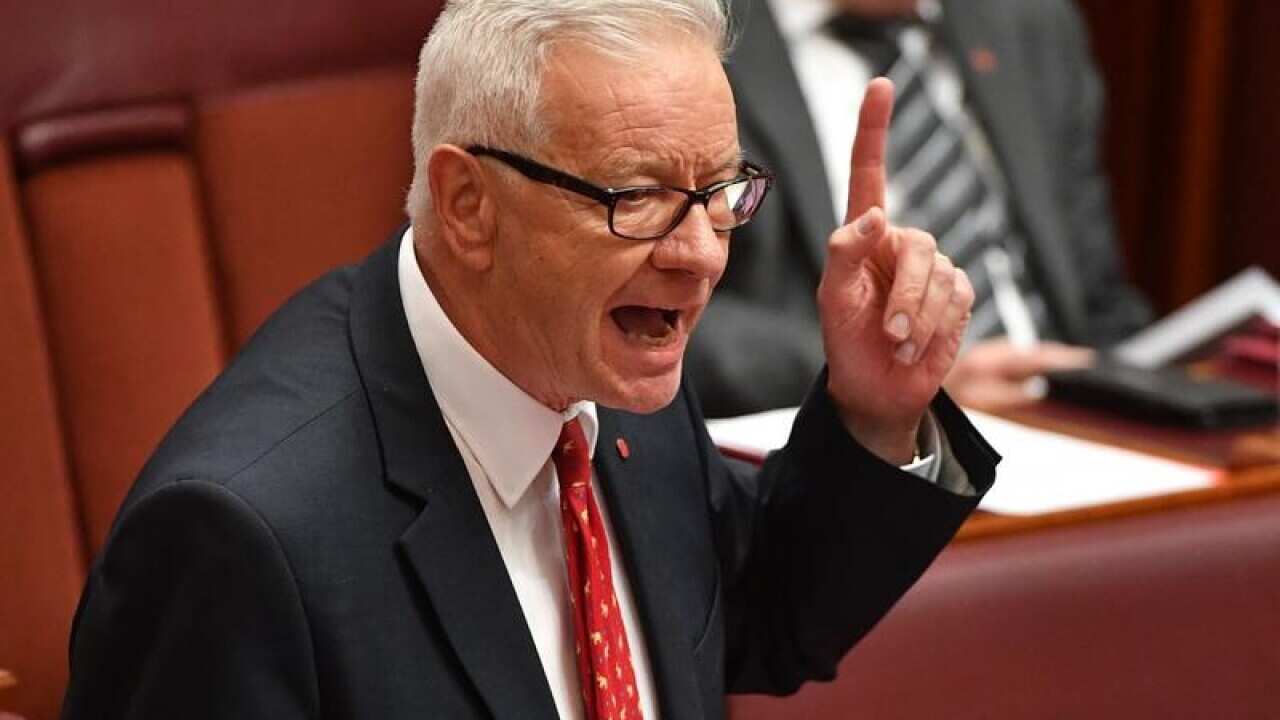 Doug Cameron responds gestures in the Senate Chamber.