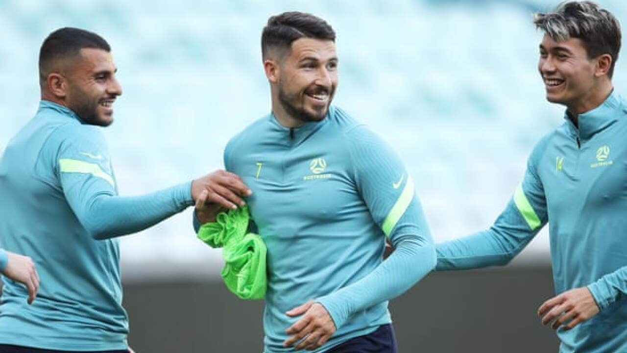 Mathew Leckie having some fun at training.