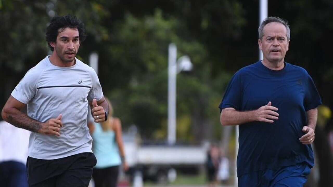 Bill Shorten and Jonathan Thurston on a run in Townsville.