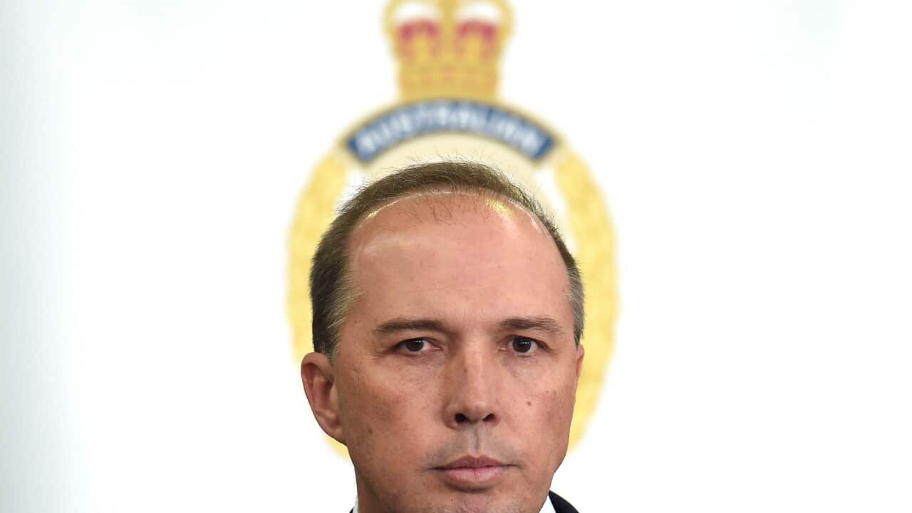 Minister for Immigration and Border Protection, Peter Dutton, answers a question during a visit to the Container Examination Facility in Sydney on Wednesday, July 22, 2015. (AAP Image/Paul Miller) NO ARCHIVING