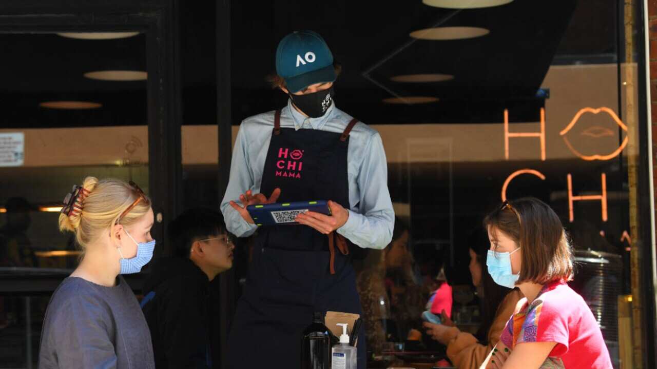 Patrons have their order taken at a restaurant in Melbourne, Wednesday, 28 October, 2020.