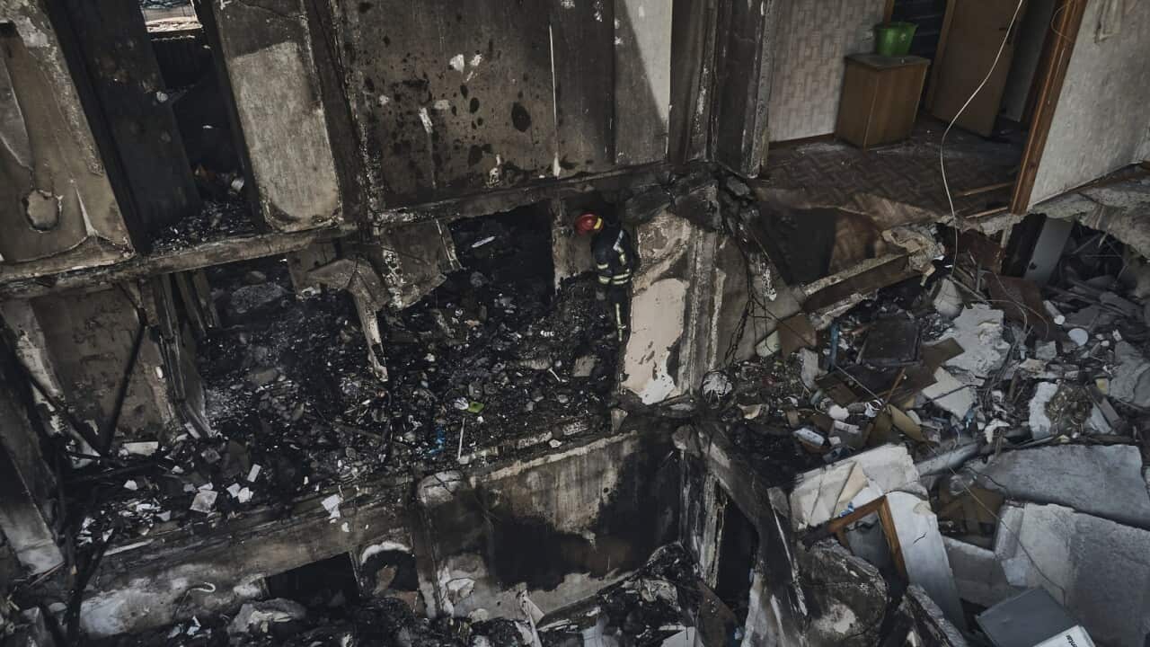 Emergency services work after a missile hit an apartment building in Kryvyi Rih, Ukraine