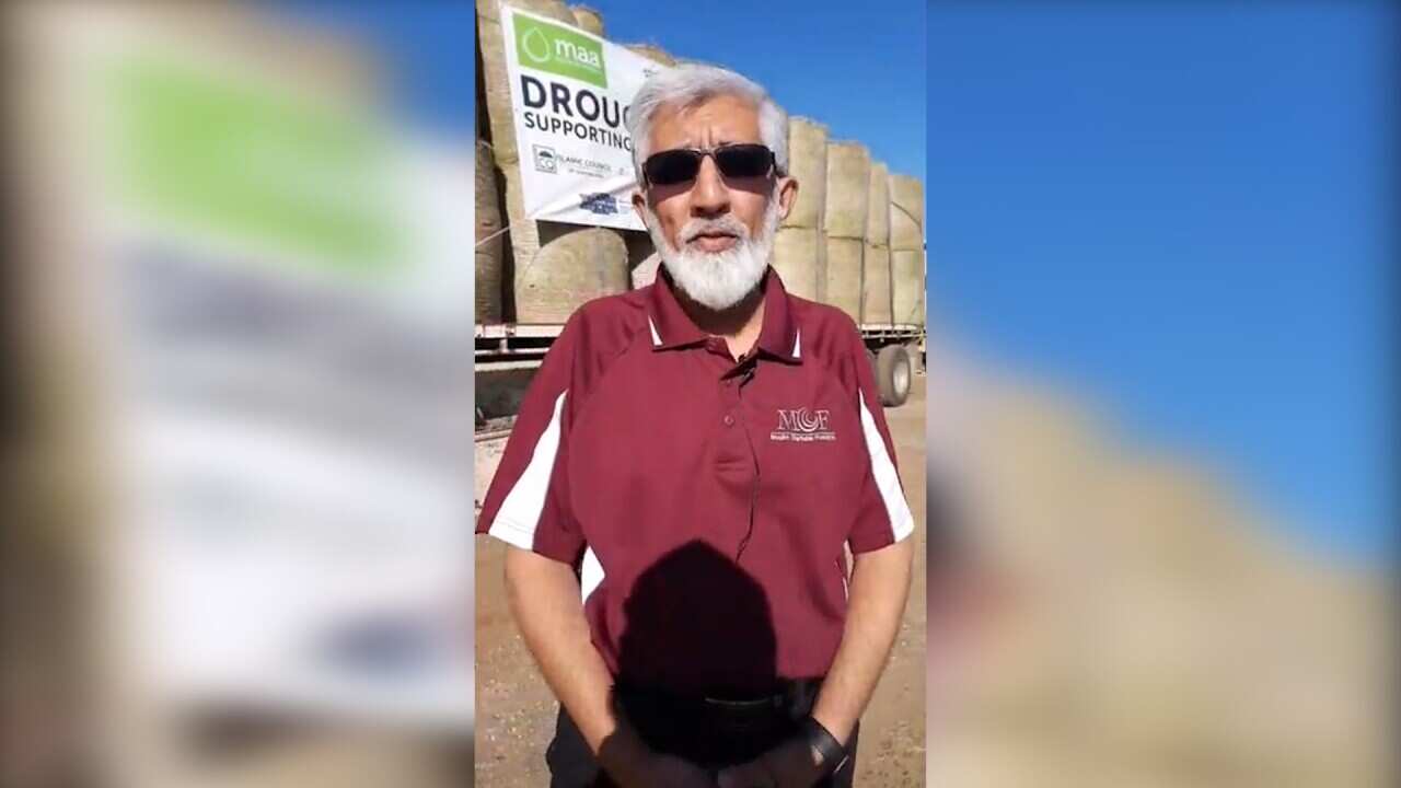A spokesperson from Muslim Charitable Foundation takes part in the hay drop.