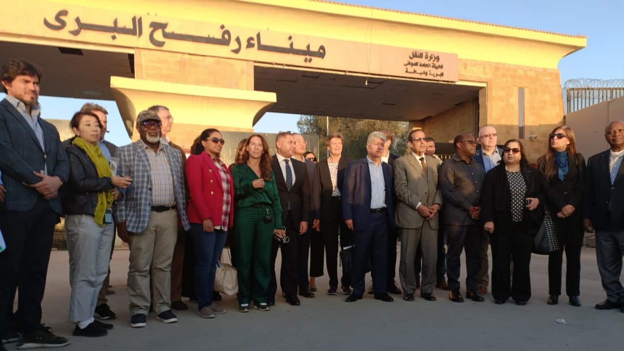 A delegation from the UN stands in front of the Rafah border crossing between Egypt and Gaza (AAP)