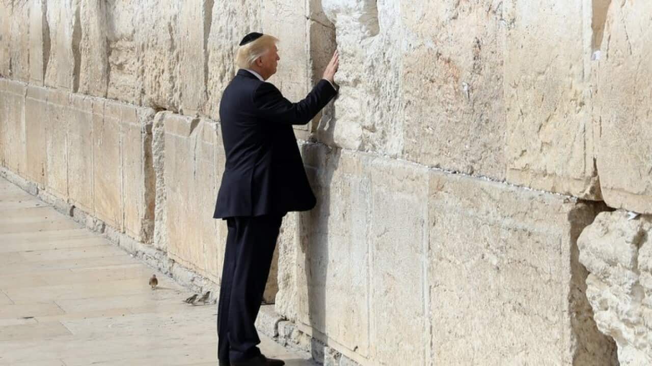 US President Donald Trump touches the Western Wall, Judaism's holiest prayer site, in Jerusalem's Old City, 22 May 2017.