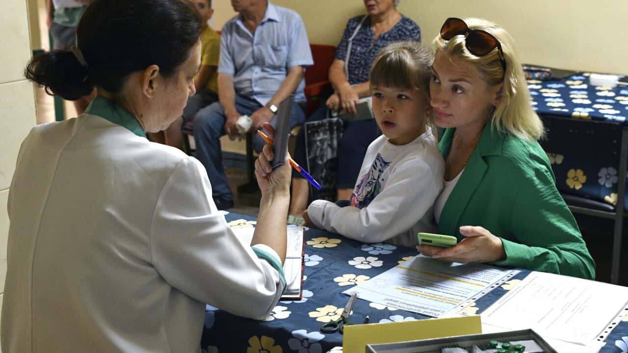 People receive iodine-containing tablets at a distribution point in Zaporizhzhia