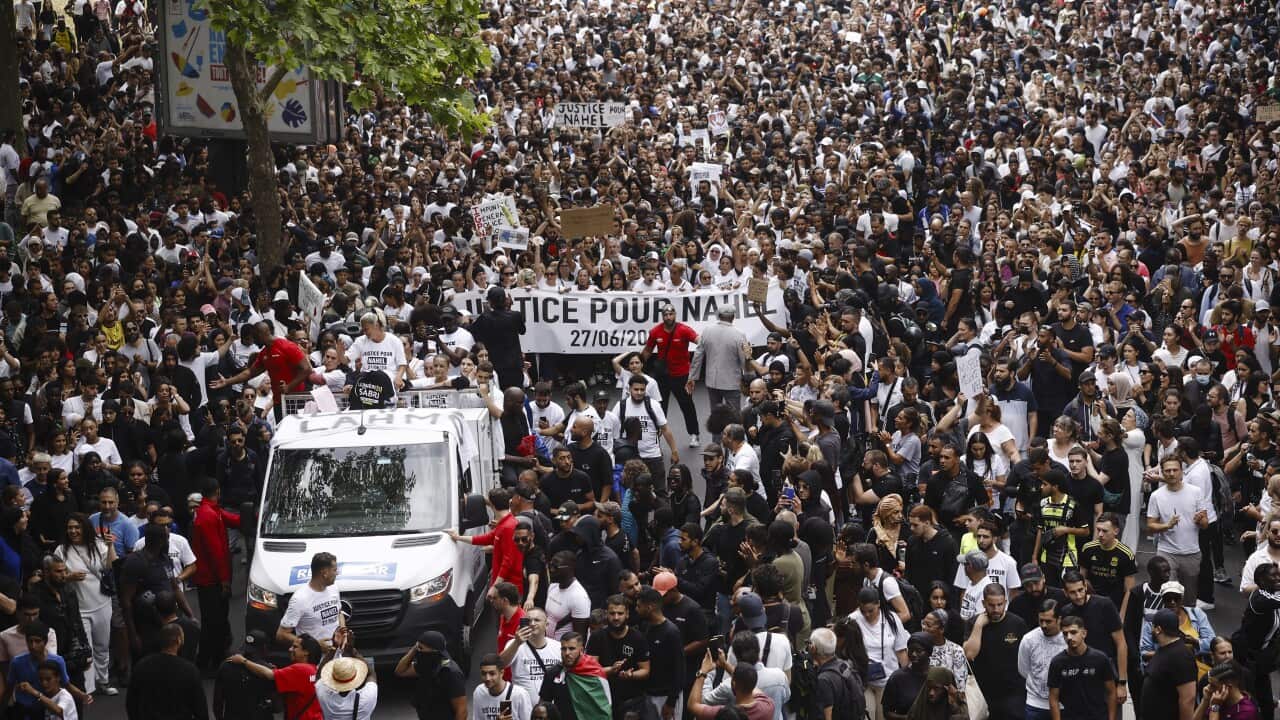 Thousands of protesters marching in Paris with a banners saying "Justice for Nahel", the 17 year old victim of a police shooting.