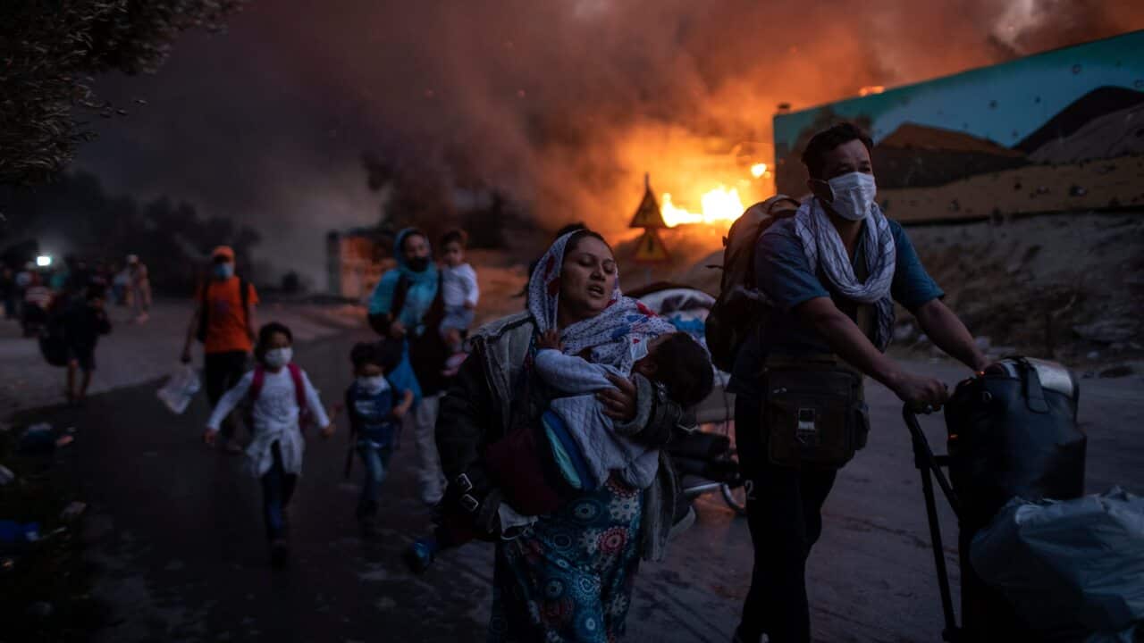Migrants flee from the Moria refugee camp during a fire on the northeastern Aegean island of Lesbos, Greece.