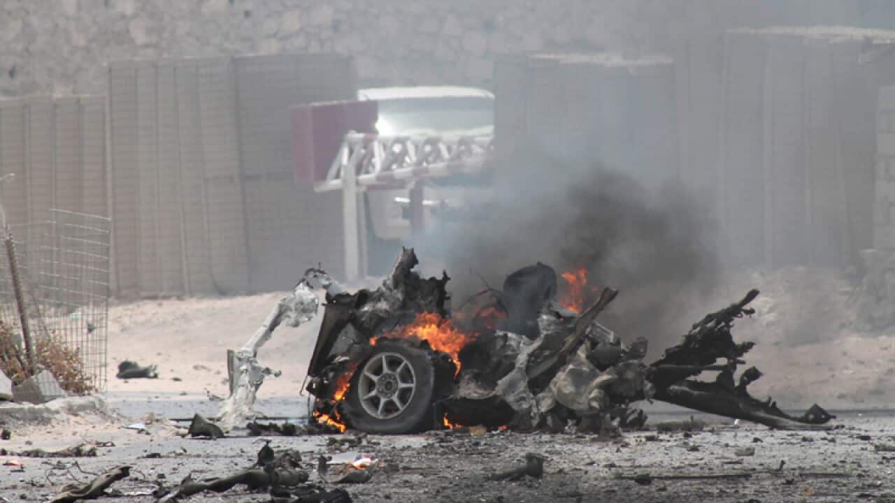 The remains of a burning vehicle outside Mogadishu airport