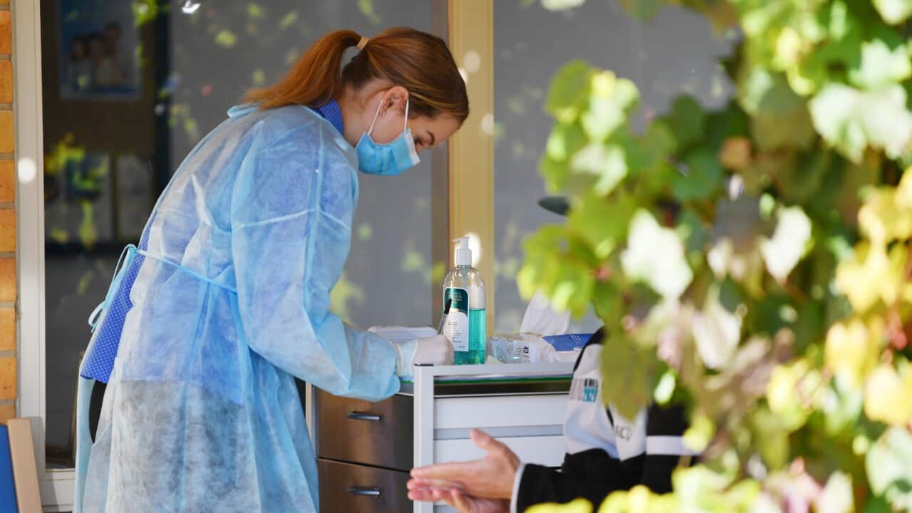 A nurse at the Tanunda medical centre screens patients outside the clinic in the Barossa Valley, northeast of Adelaide, Tuesday, March 31, 2020. The Barossa Valley has had a cluster of 34 cases of coronavirus. (AAP Image/David Mariuz) NO ARCHIVING