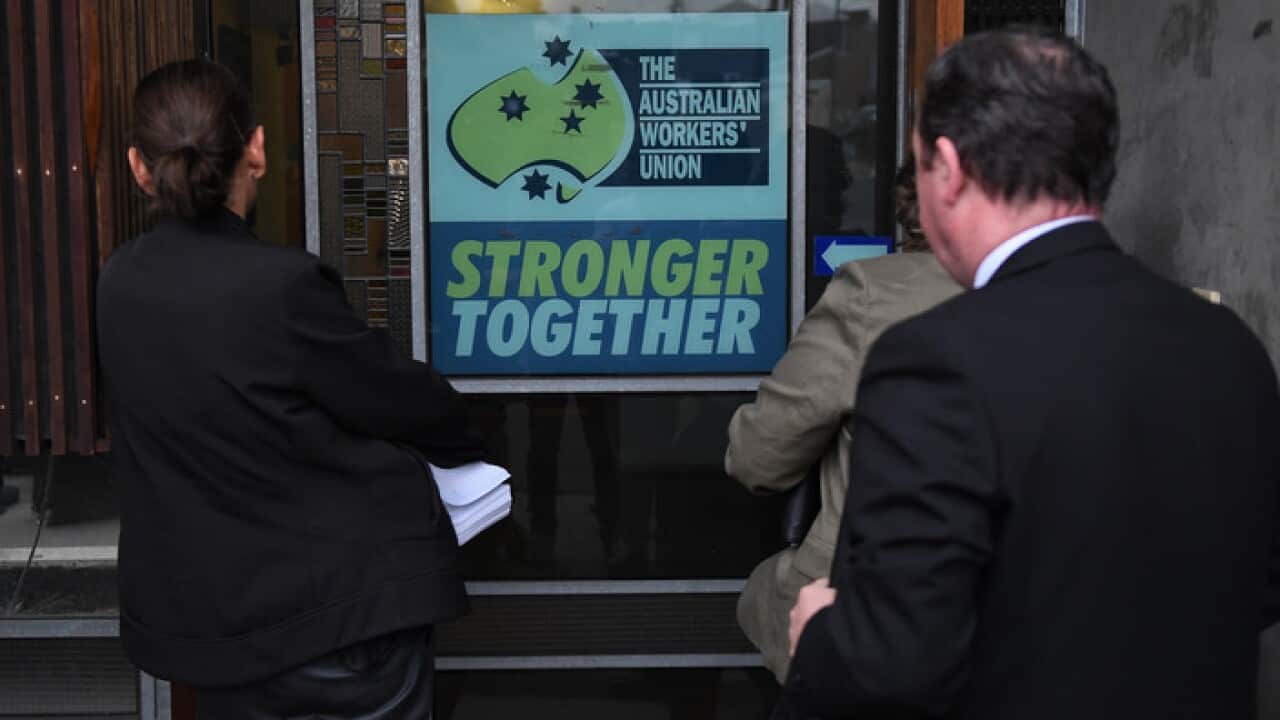Federal police officers arrive at the offices of the Victorian brach of the AWU in west Melbourne.