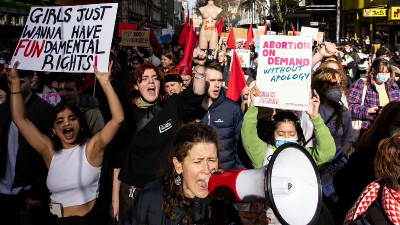 Demonstrators hold placards and signs as they march on Elizabeth Street during a rally in support of abortion rights in Melbourne, Saturday, July 2, 2022.
