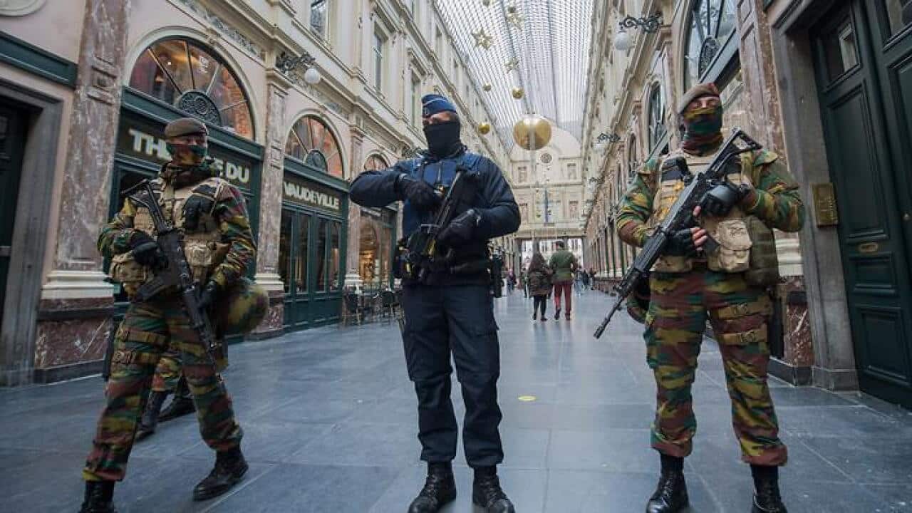 Police officer and soldiers on security duty inside Galerie de la Reine. (EPA)
