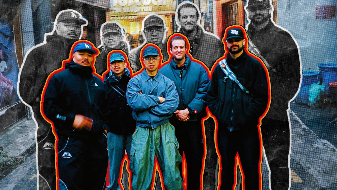 Five men standing on a street. There's an orange outline around them.