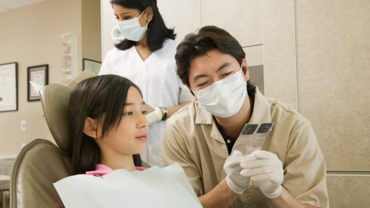 Dentist discussing x-rays with a young patient