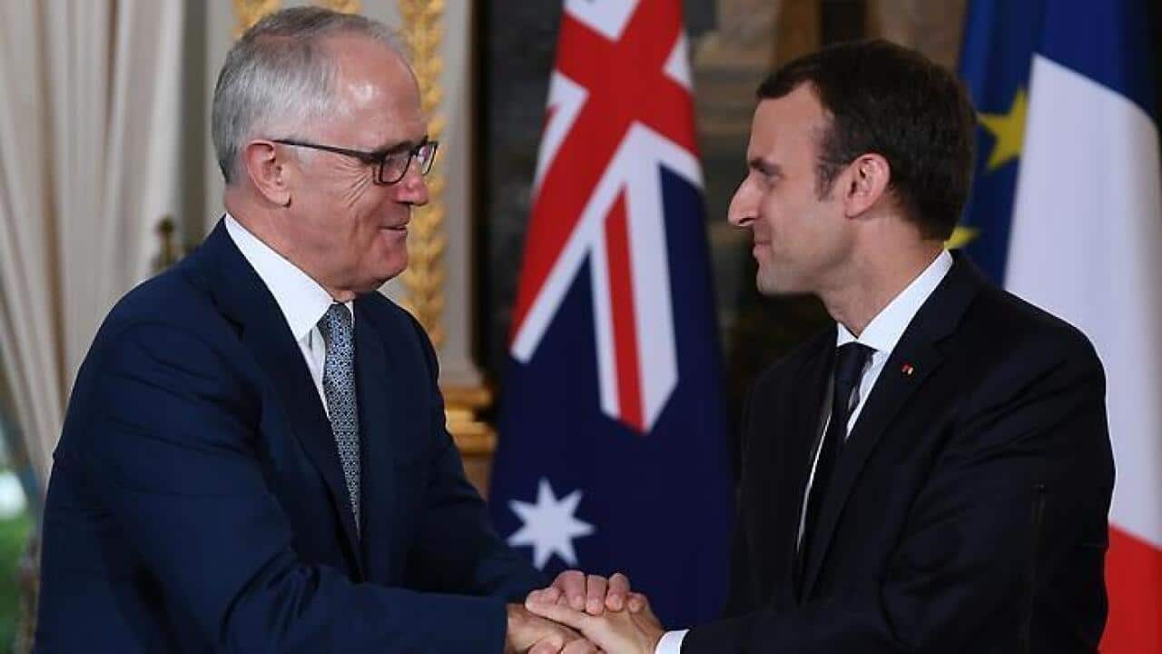 French President Emmanuel Macro shakes hands with PM.