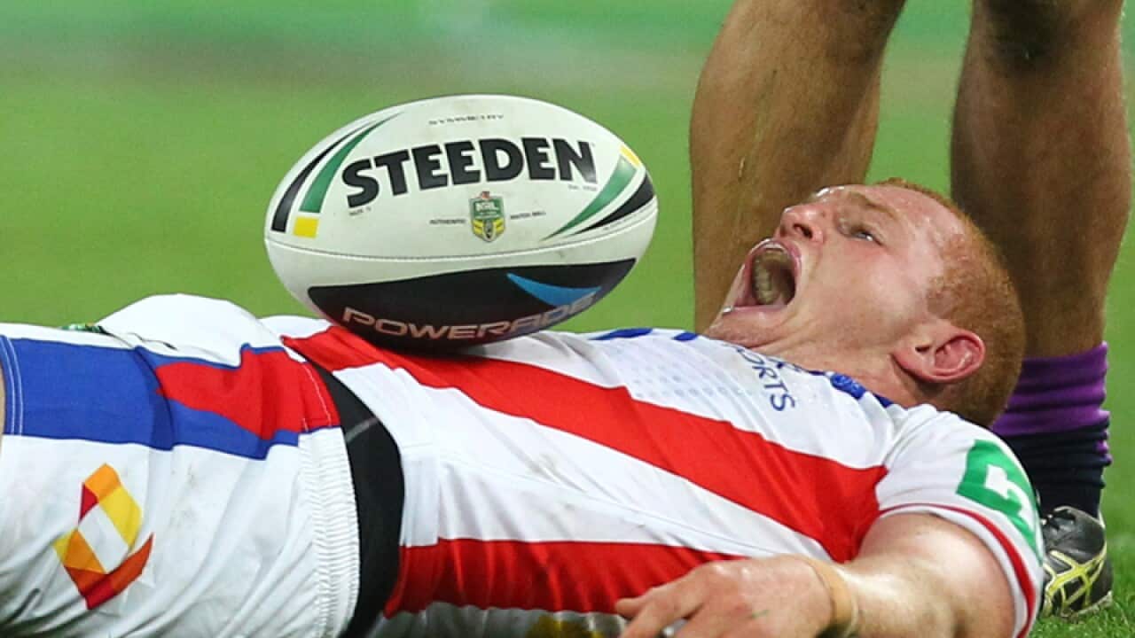 Newcastle Knights utility forward Alex McKinnon lies on the ground