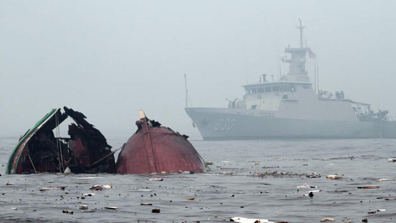 An Indonesian Navy ship patrol as a fishing vessels from Vietnam sinks