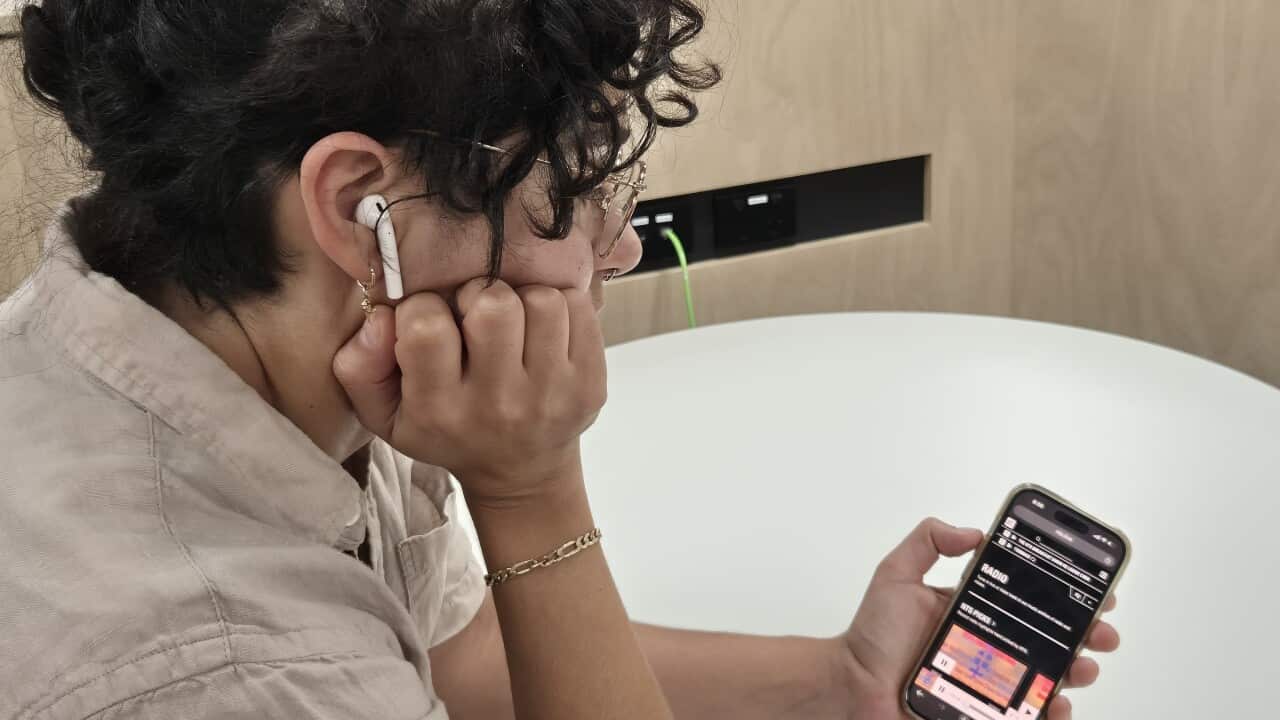 A woman listening to the radio on her cell phone. Photo courtency Tal/SPD.