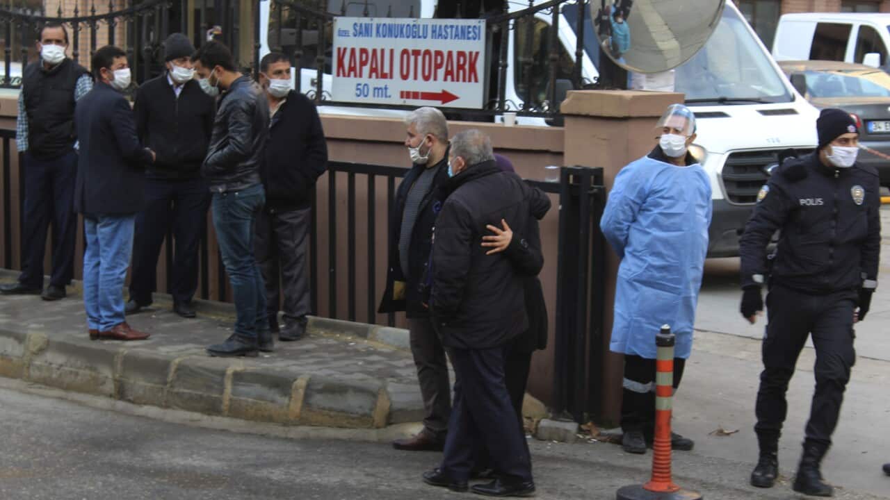 People, police and medics gather outside the privately-run Sanko University Hospital in Gaziantep, Turkey, Saturday, 19 December, 2020.