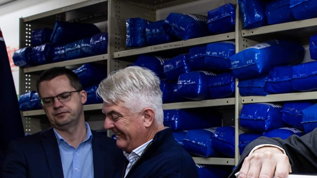 Minister for Trade, Tourism and Investment Dan Tehan pours wine in a glass during a press conference about the signing of the trade agreement with India, in Melbourne, Saturday, April 2, 2022. (AAP Image/Diego Fedele) NO ARCHIVING