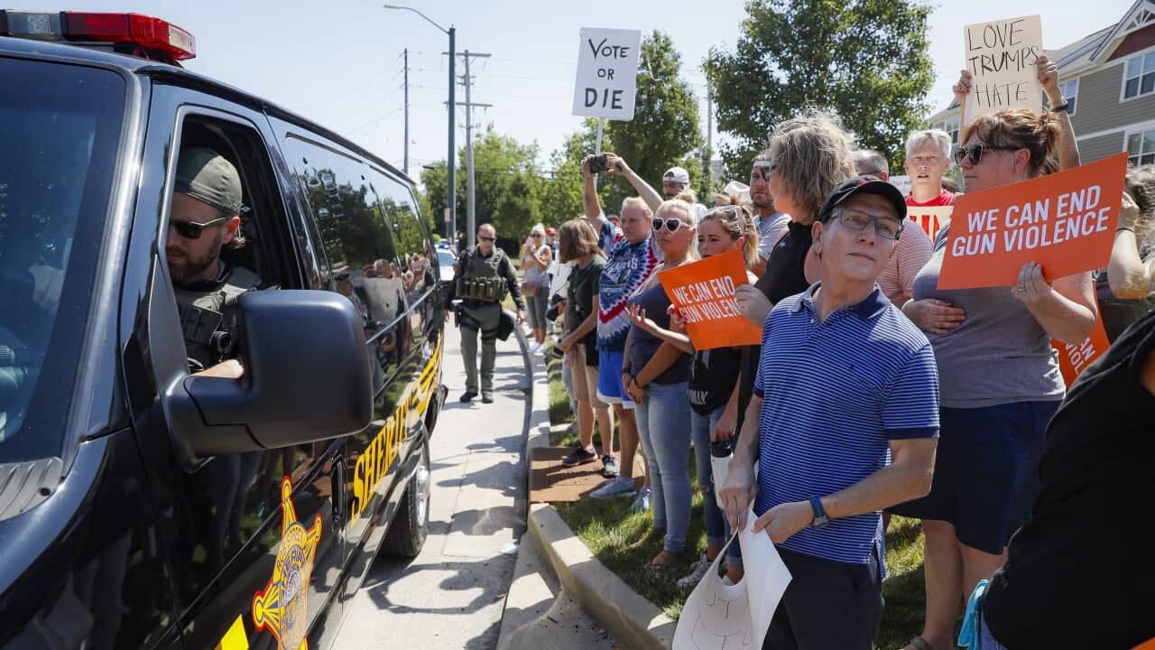 Demonstrators gather for the arrival of President Donald Trump outside Miami Valley Hospital.