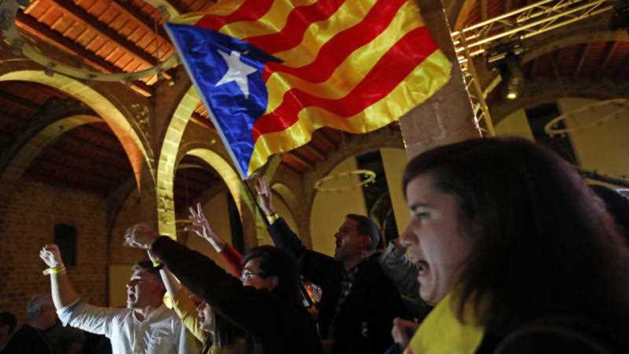 Catalan independence supporters wave a 'estelada' ( pro-independence Catalan flag ) celebrate at the ANC ( Catalan National Assembly ) headquarters after results of the regional elections in Barcelona, Spain, Thursday, December 21, 2017.