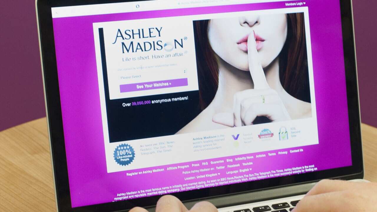 A man wearing a wedding ring looking at the Ashley Madison website