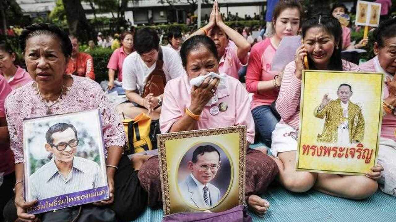 Thai well-wishers weep as they pray for Thai King Bhumibol Adulyadej's recovery at the Siriraj Hospital in Bangkok, Thailand