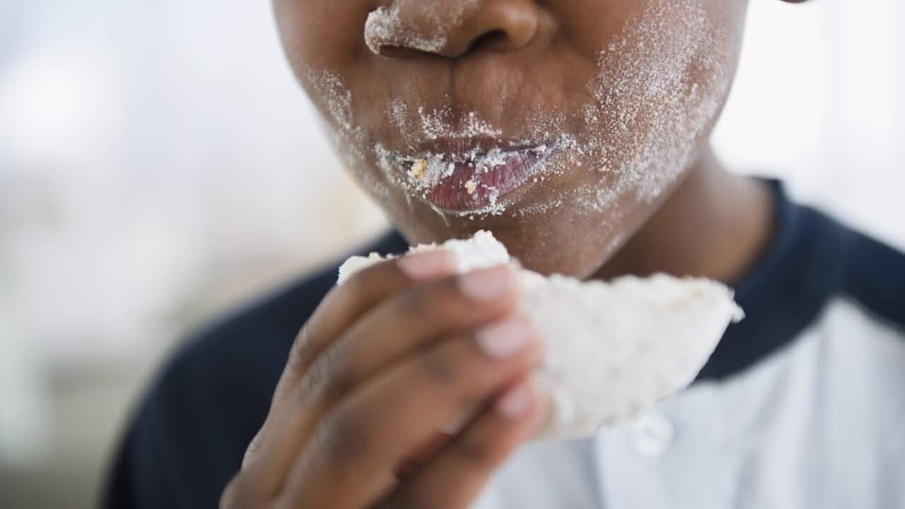 Boy eating a sugary donut