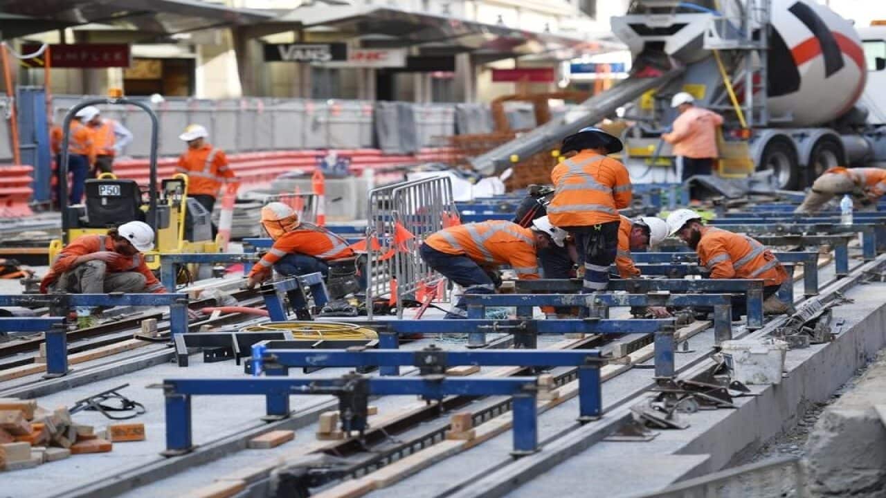 Construction workers are seen building a light rail project in Sydney